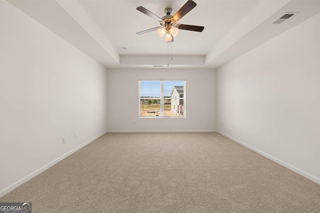 12085 Conrad Cir, Hampton, GA 30228 - spare room featuring a raised ceiling, light carpet, and ceiling fan
