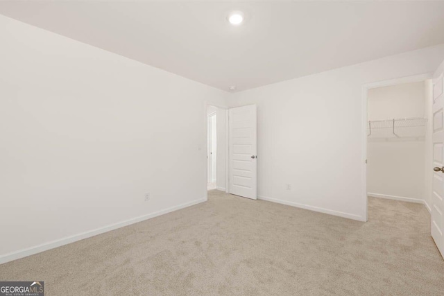 12085 Conrad Cir, Hampton, GA 30228 - unfurnished bedroom with carpet, a spacious closet, a closet, and recessed lighting