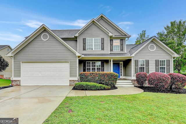 327 Oakland Bay Ct, Loganville, GA 30052 - view of front of property featuring concrete driveway, a front lawn, a garage, roof with shingles, and covered porch