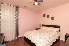 1405 Overland Xing, Alpharetta, GA 30004 - bedroom featuring dark wood finished floors, baseboards, and ceiling fan