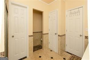 1405 Overland Xing, Alpharetta, GA 30004 - bathroom featuring a wainscoted wall, tile walls, and ornamental molding