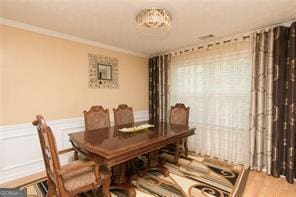 1405 Overland Xing, Alpharetta, GA 30004 - dining room with wood finished floors, a wainscoted wall, and ornamental molding
