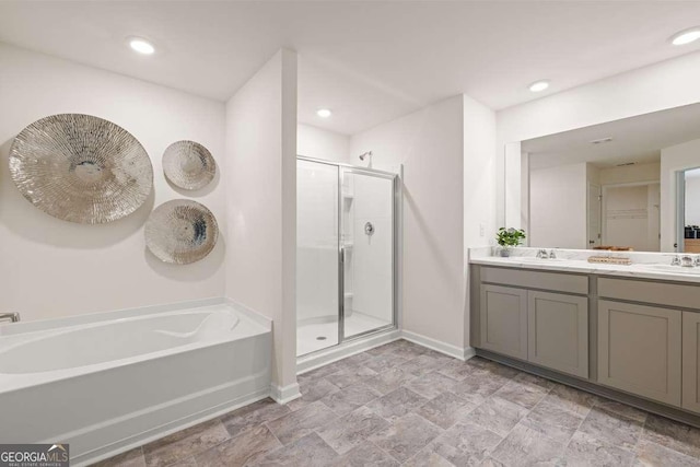 1311 Aura Ln, Lawrenceville, GA 30045 - bathroom with a bath, a stall shower, double vanity, stone finish flooring, and recessed lighting