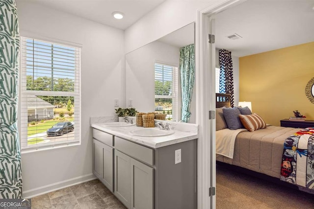 1311 Aura Ln, Lawrenceville, GA 30045 - ensuite bathroom featuring double vanity and baseboards