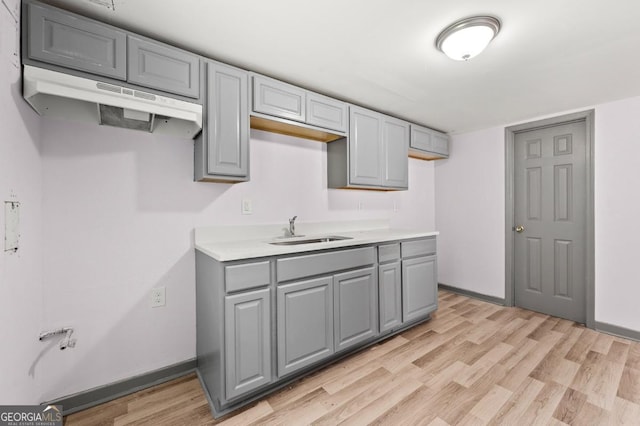 2110 Newnan St, Atlanta, GA 30344 - kitchen with gray cabinetry, light wood-style floors, and light countertops