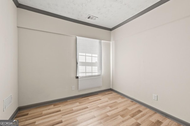 2110 Newnan St, Atlanta, GA 30344 - unfurnished room with ornamental molding, light wood-style flooring, and a textured ceiling