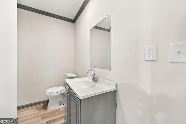 2110 Newnan St, Atlanta, GA 30344 - half bathroom with ornamental molding, vanity, and wood finished floors
