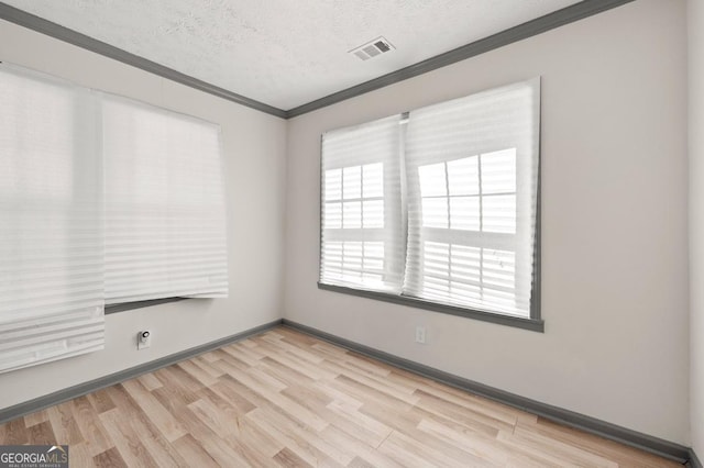 2110 Newnan St, Atlanta, GA 30344 - spare room with ornamental molding, light wood-style floors, and a textured ceiling