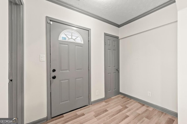 2110 Newnan St, Atlanta, GA 30344 - entrance foyer featuring a textured ceiling, light wood-style flooring, and crown molding