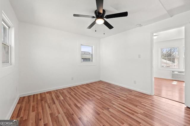 2110 Newnan St, Atlanta, GA 30344 - spare room with light wood-type flooring, a wall mounted AC, and a ceiling fan