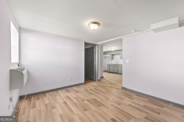 2110 Newnan St, Atlanta, GA 30344 - empty room with light wood-style floors and a smoke detector