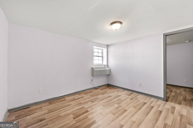 2110 Newnan St, Atlanta, GA 30344 - unfurnished room featuring light wood-style floors, a wall mounted AC, and cooling unit