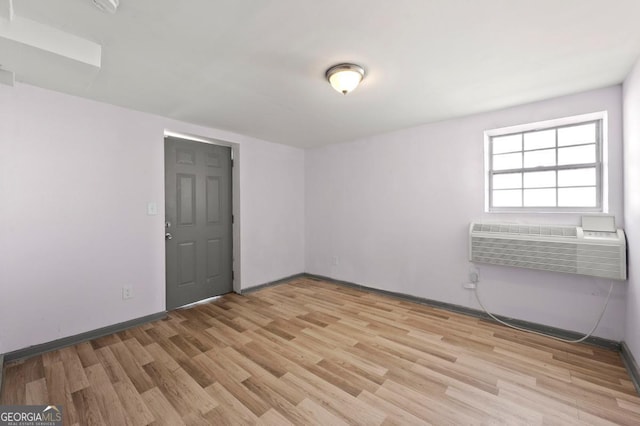 2110 Newnan St, Atlanta, GA 30344 - unfurnished room featuring light wood-style flooring and a wall mounted AC