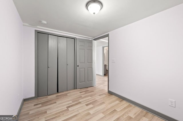 2110 Newnan St, Atlanta, GA 30344 - unfurnished bedroom featuring light wood finished floors and a closet