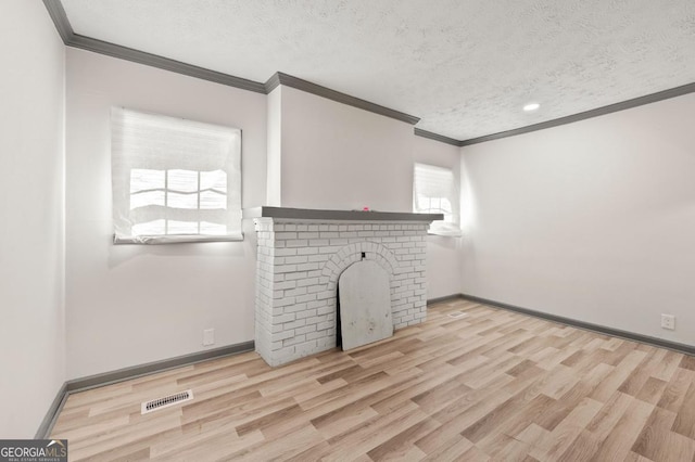2110 Newnan St, Atlanta, GA 30344 - unfurnished living room featuring crown molding, a textured ceiling, a fireplace, wood finished floors, and recessed lighting