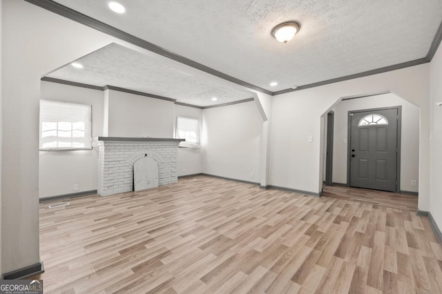 2110 Newnan St, Atlanta, GA 30344 - unfurnished living room with crown molding, a textured ceiling, wood finished floors, arched walkways, and recessed lighting