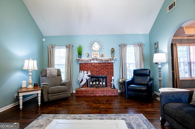 1612 Cagle Ct, Lawrenceville, GA 30045 - living room with lofted ceiling, hardwood / wood-style flooring, arched walkways, a fireplace, and baseboards