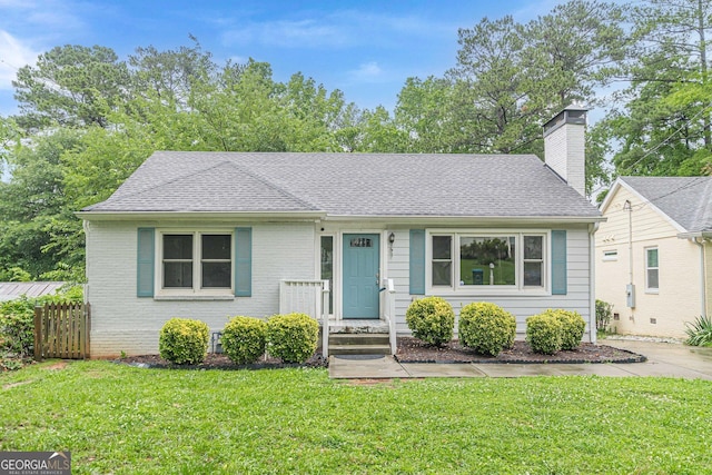 489 Radar Dr, Hapeville, GA 30354 - bungalow-style home with a front lawn, a shingled roof, a chimney, and brick siding