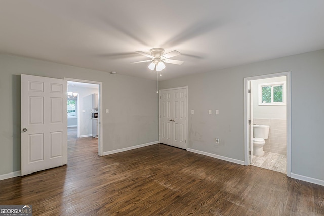 489 Radar Dr, Hapeville, GA 30354 - unfurnished bedroom featuring dark wood-type flooring, a closet, baseboards, connected bathroom, and a ceiling fan