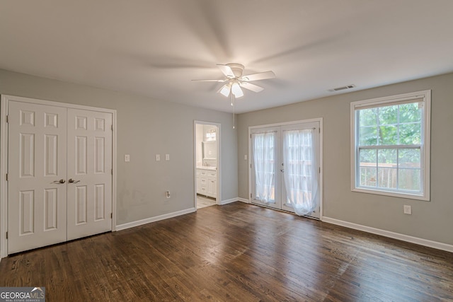 489 Radar Dr, Hapeville, GA 30354 - unfurnished bedroom featuring dark wood-style flooring, baseboards, a ceiling fan, ensuite bathroom, and access to exterior