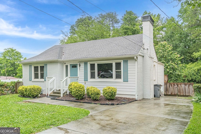 489 Radar Dr, Hapeville, GA 30354 - bungalow-style house with a chimney, roof with shingles, driveway, and brick siding