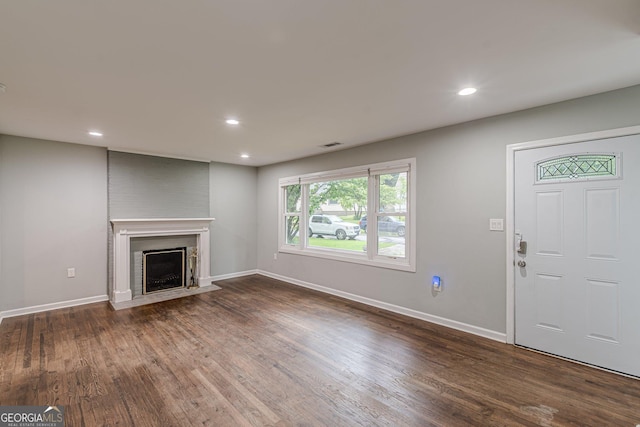 489 Radar Dr, Hapeville, GA 30354 - unfurnished living room featuring dark wood-style floors, baseboards, recessed lighting, and a fireplace with flush hearth