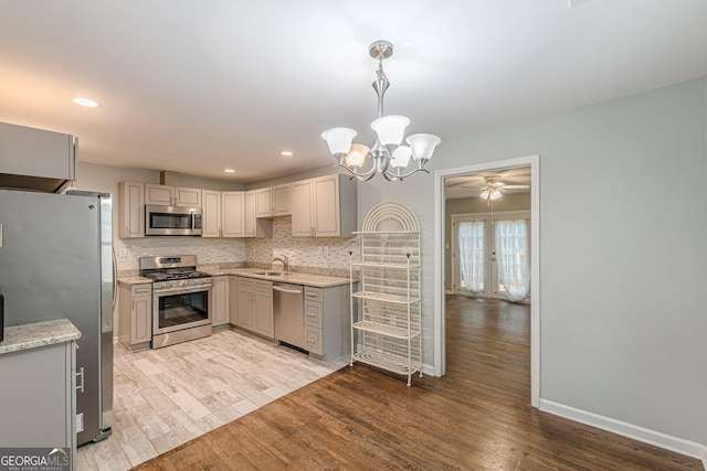 489 Radar Dr, Hapeville, GA 30354 - kitchen featuring stainless steel appliances, a sink, light wood-style flooring, baseboards, and recessed lighting