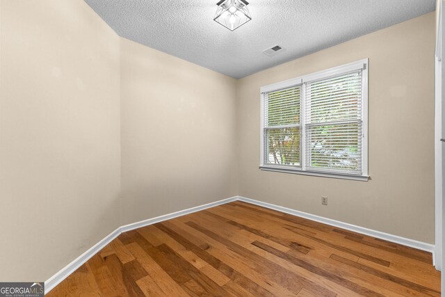 130 Augusta Dr, Peachtree City, GA 30269 - empty room with baseboards, wood finished floors, and a textured ceiling