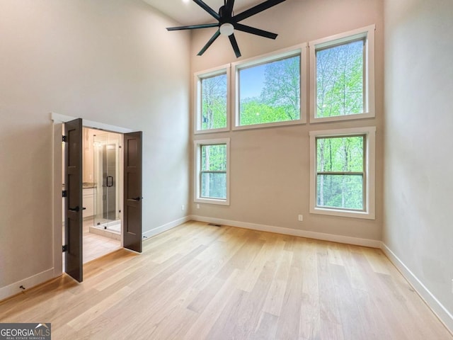 54 Myna, Ellijay, GA 30540 - spare room featuring a high ceiling, ceiling fan, plenty of natural light, and light wood-type flooring