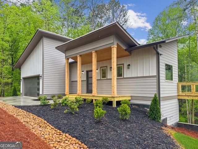 54 Myna, Ellijay, GA 30540 - view of front of house with board and batten siding, a porch, an attached garage, and driveway