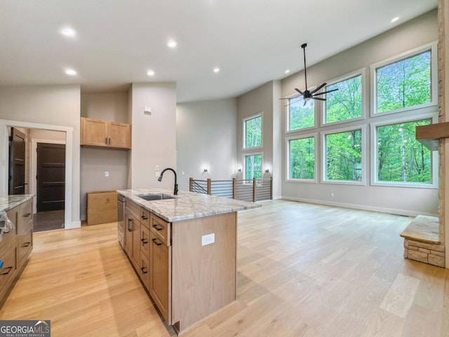 54 Myna, Ellijay, GA 30540 - kitchen featuring ceiling fan, recessed lighting, light stone counters, light wood-style floors, and an island with sink