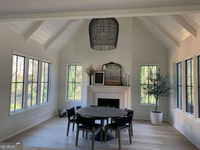 1303 Cobblemill Way NW, Kennesaw, GA 30152 - dining space with healthy amount of natural light, a fireplace, wood finished floors, high vaulted ceiling, and a wood ceiling with exposed beams
