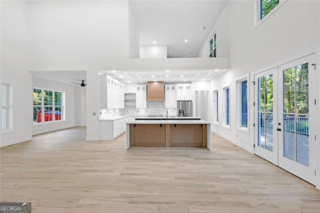 2764 Midway Rd, Decatur, GA 30030 - kitchen with french doors, stainless steel fridge with ice dispenser, a high ceiling, open shelves, and light wood finished floors