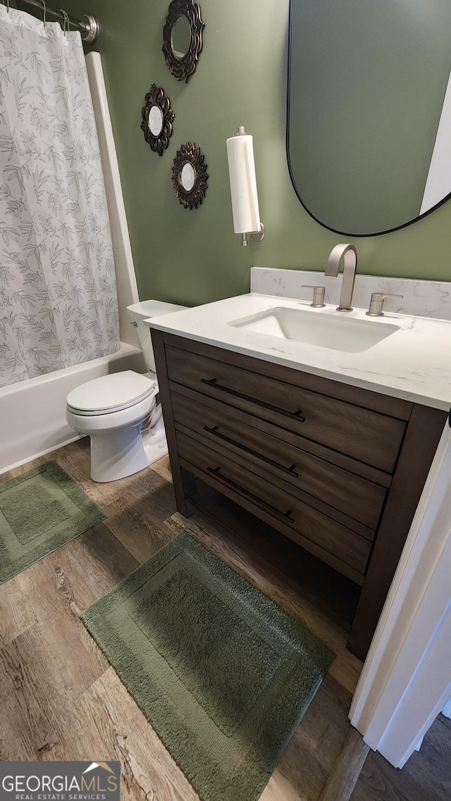 556 Constitution Dr, Forsyth, GA 31029 - full bathroom with vanity, shower / bath combo, toilet, and wood finished floors