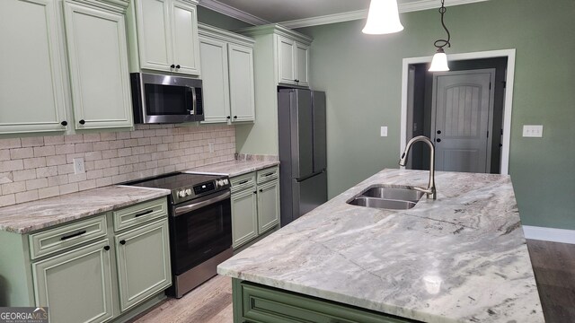 556 Constitution Dr, Forsyth, GA 31029 - kitchen with stainless steel appliances, a sink, crown molding, light wood-style flooring, and tasteful backsplash