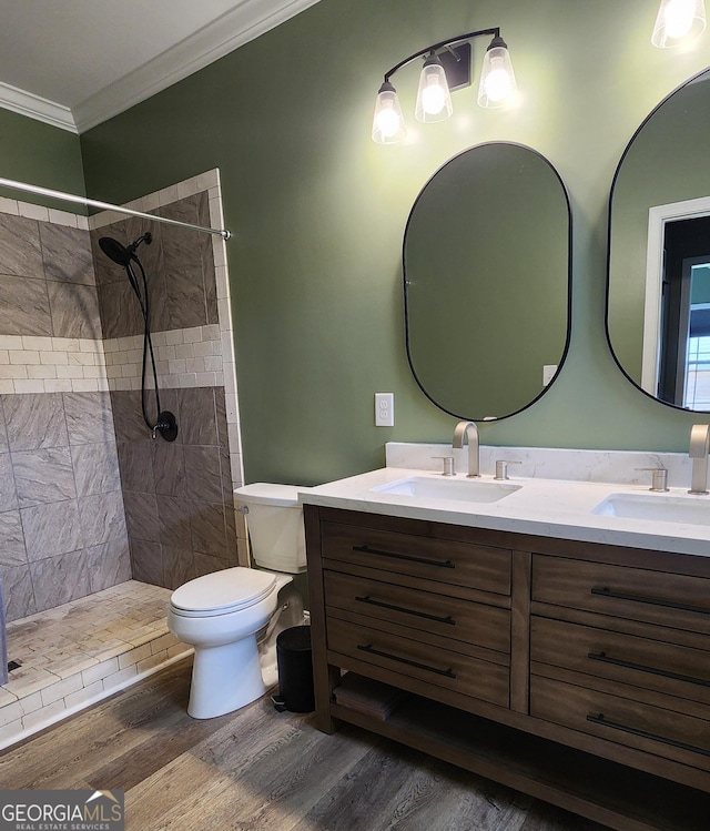 556 Constitution Dr, Forsyth, GA 31029 - full bath with double vanity, toilet, crown molding, wood finished floors, and tiled shower