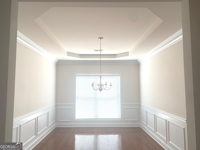2118 Water Mill Ct, Buford, GA 30519 - unfurnished dining area with a raised ceiling, a chandelier, a decorative wall, a wainscoted wall, and dark wood-type flooring