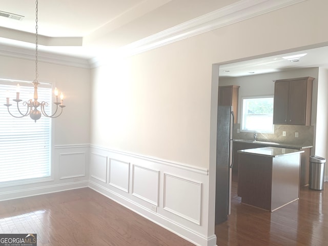 2118 Water Mill Ct, Buford, GA 30519 - unfurnished dining area featuring a chandelier, dark wood-type flooring, a wainscoted wall, crown molding, and a raised ceiling