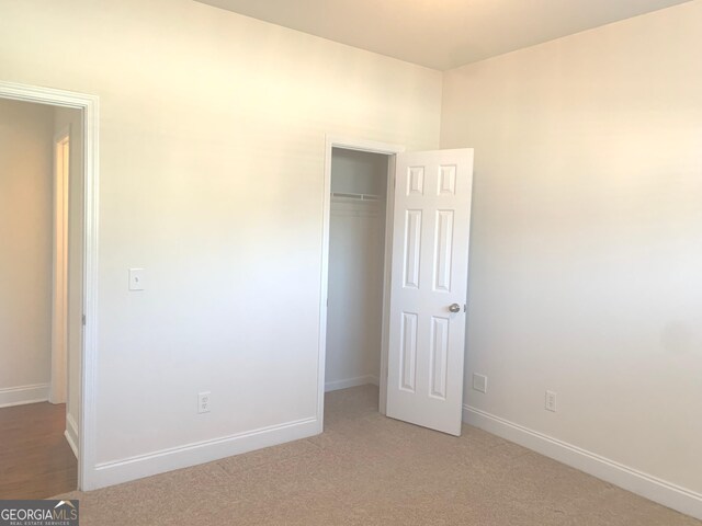 2118 Water Mill Ct, Buford, GA 30519 - unfurnished bedroom with baseboards, a closet, and light carpet