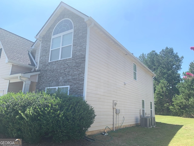 2118 Water Mill Ct, Buford, GA 30519 - view of property exterior with stone siding, a lawn, and cooling unit