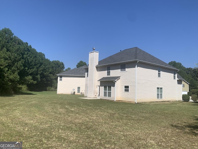 2118 Water Mill Ct, Buford, GA 30519 - rear view of house with a lawn, a chimney, and roof with shingles