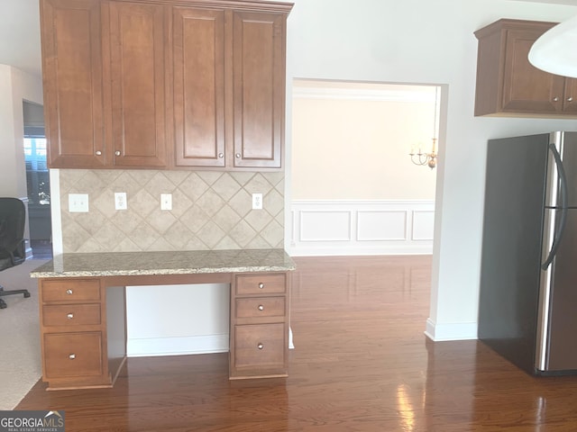 2118 Water Mill Ct, Buford, GA 30519 - kitchen with freestanding refrigerator, dark wood-style flooring, brown cabinetry, and decorative backsplash
