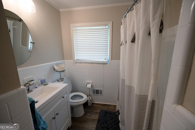 103 Wilson Way, Thomaston, GA 30286 - bathroom featuring tile walls, vanity, wood finished floors, ornamental molding, and a wainscoted wall
