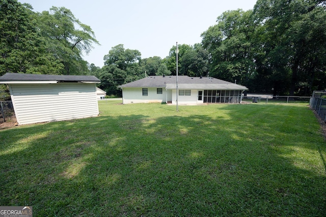 103 Wilson Way, Thomaston, GA 30286 - rear view of house featuring a sunroom and an outbuilding