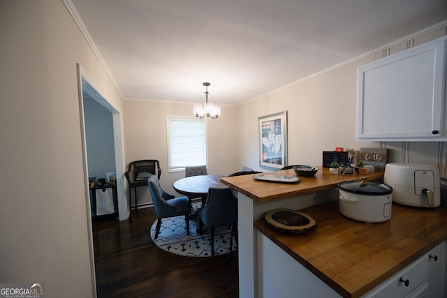 103 Wilson Way, Thomaston, GA 30286 - dining room featuring dark wood-type flooring, a chandelier, and crown molding