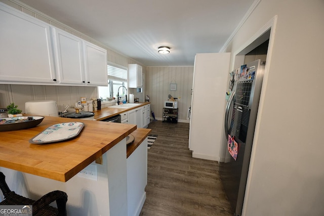 103 Wilson Way, Thomaston, GA 30286 - kitchen with white cabinetry, crown molding, wooden counters, dark wood-type flooring, and a breakfast bar