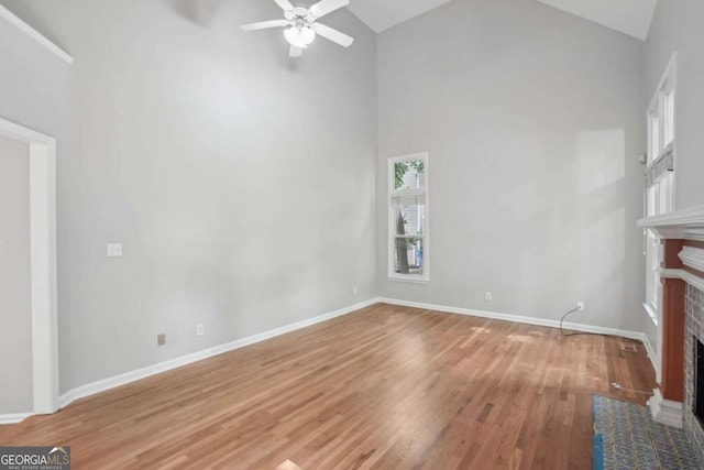 220 Chinkapin Cir SW, South Fulton, GA 30311 - unfurnished living room featuring a fireplace, a ceiling fan, wood finished floors, and high vaulted ceiling