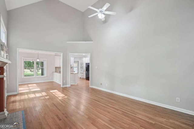 220 Chinkapin Cir SW, South Fulton, GA 30311 - unfurnished living room featuring a ceiling fan, light wood-style flooring, and high vaulted ceiling