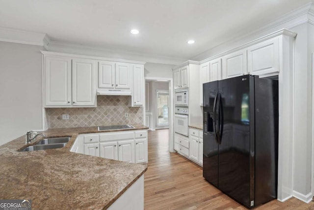 220 Chinkapin Cir SW, South Fulton, GA 30311 - kitchen with black appliances, under cabinet range hood, white cabinetry, crown molding, and recessed lighting