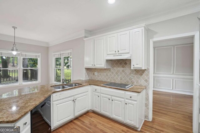 220 Chinkapin Cir SW, South Fulton, GA 30311 - kitchen with black appliances, under cabinet range hood, white cabinetry, light wood-type flooring, and tasteful backsplash